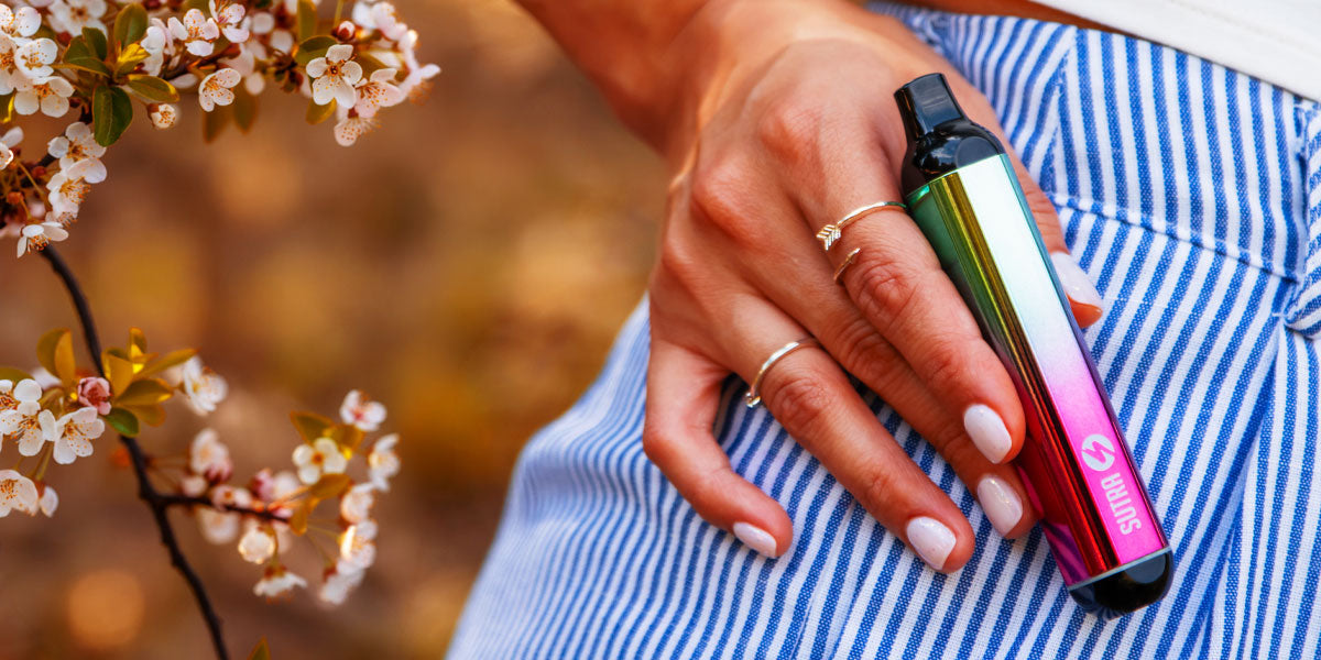 Woman holding Sutra SILO near spring flowers